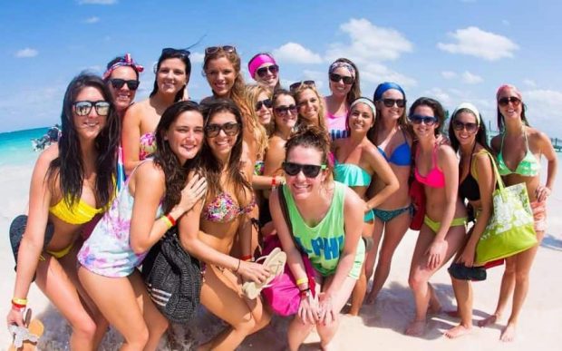 Group of students enjoying a day at the beach during Senior Week